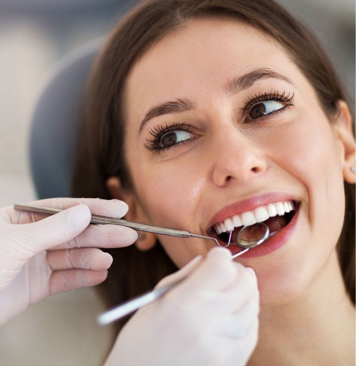 Woman having checked by dentist