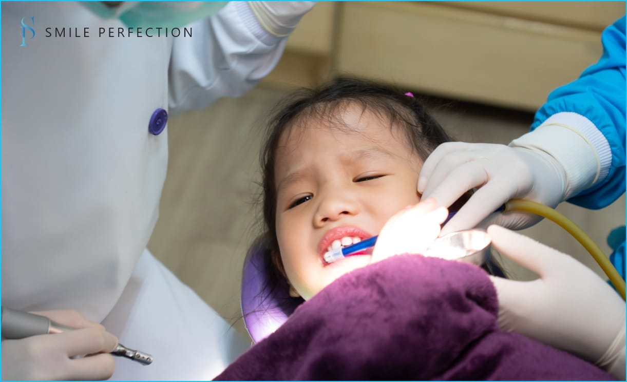 Portrait of cute baby girl having dental checkup