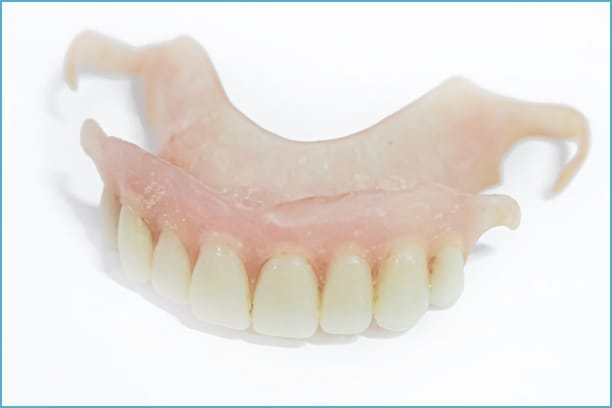 Close-up view of the top part of a denture, featuring realistic teeth and gum design, crafted to fit securely and restore upper dental functionality.